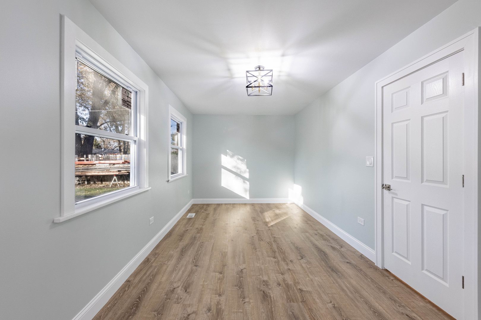 1817 Kelly Avenue Crest Hill, IL 60403 - Photo 10 of 22 a view of an empty room with wooden floor and a window