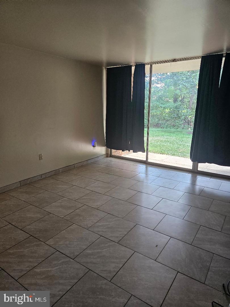 8481 Greenbelt Road, Unit T2 Greenbelt, MD 20770 - Photo 19 of 22 a view of an empty room with floor to ceiling window and floor to ceiling window