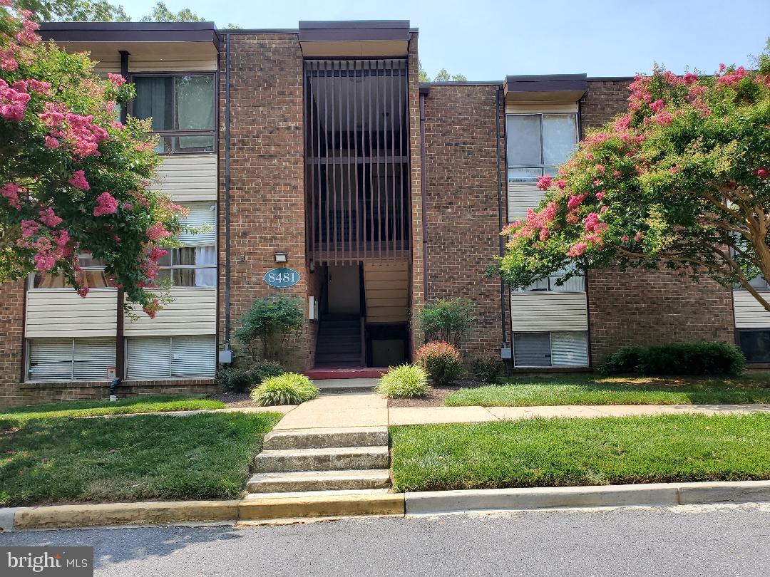 8481 Greenbelt Road, Unit T2 Greenbelt, MD 20770 - Photo 2 of 22 a front view of a house with a yard and fountain
