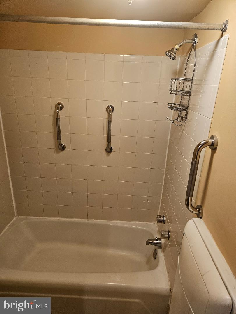 8481 Greenbelt Road, Unit T2 Greenbelt, MD 20770 - Photo 21 of 22 a bathroom with a shower and toilet