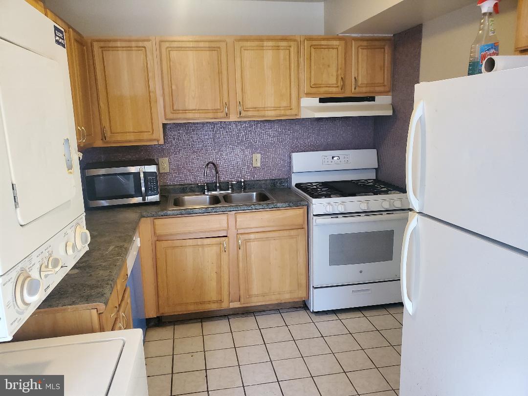 8481 Greenbelt Road, Unit T2 Greenbelt, MD 20770 - Photo 7 of 22 a kitchen with granite countertop cabinets stainless steel appliances and a sink