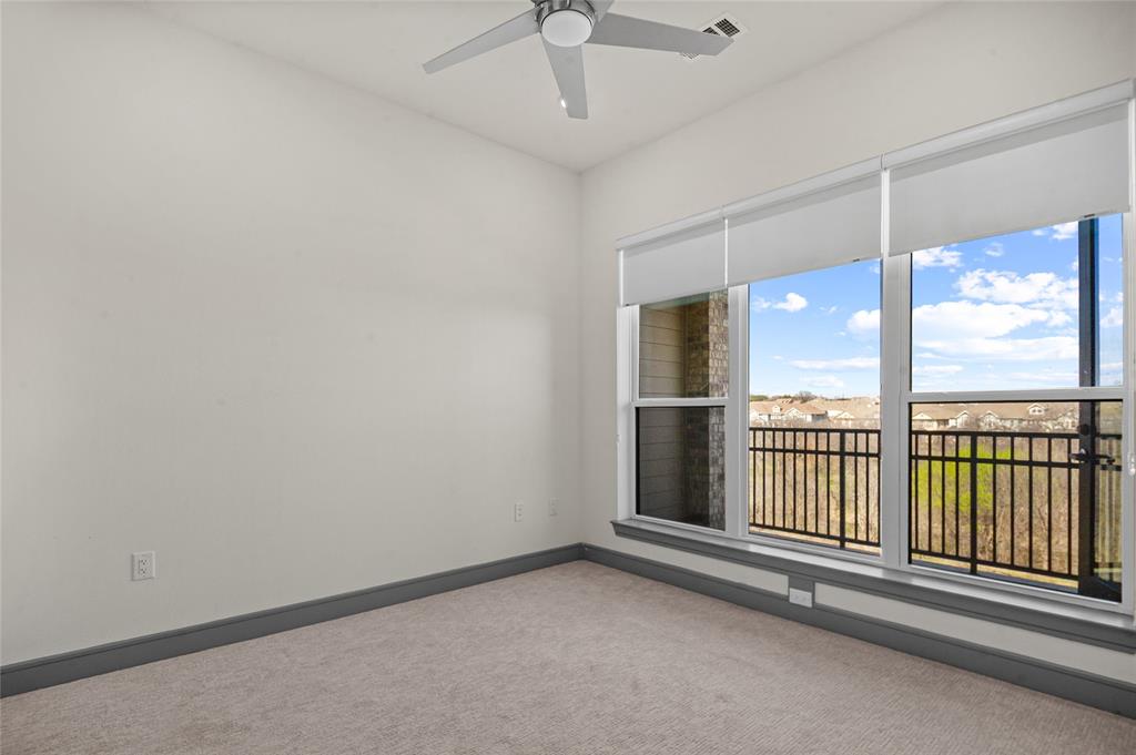 2700 Old Denton Road, Unit 3318 Carrollton, TX 75007 - Photo 4 of 24 Carpeted secondary bedroom with ceiling fan and baseboards- View of the balcony