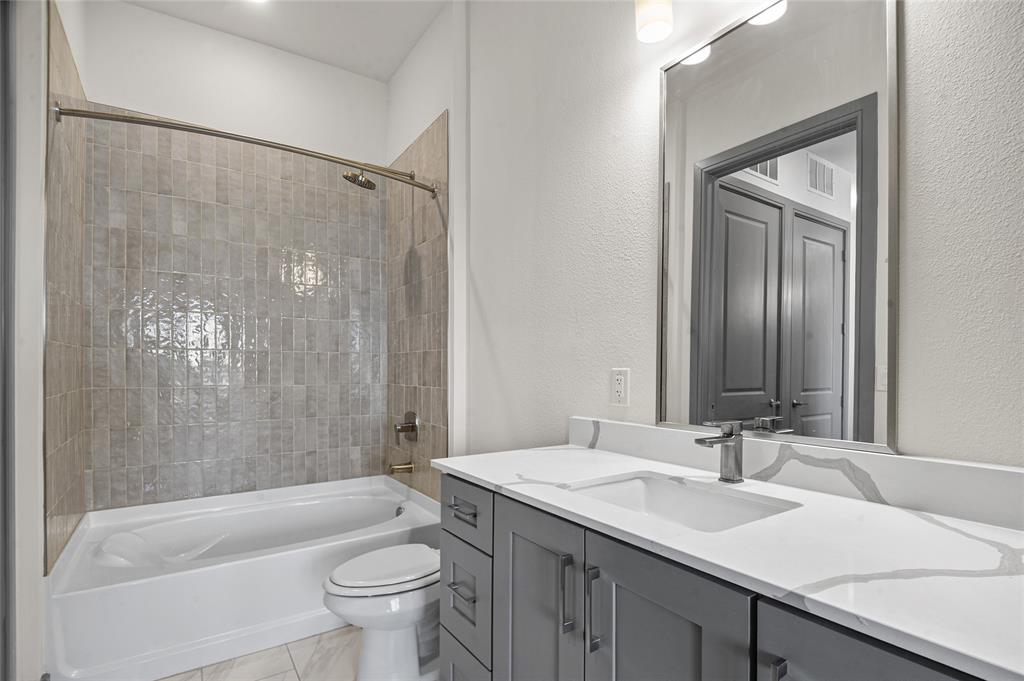 2700 Old Denton Road, Unit 3318 Carrollton, TX 75007 - Photo 5 of 24 Full bathroom with bathing tub / shower combination, vanity, and a tiled wall. Almost the second master bath