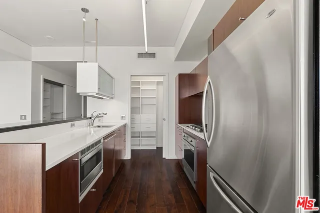 a kitchen with a stove and a refrigerator