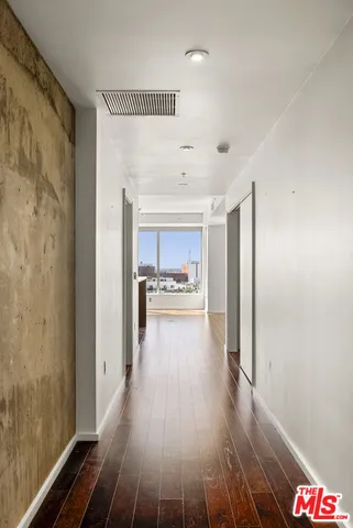 a view of a hallway view with wooden floor and furniture