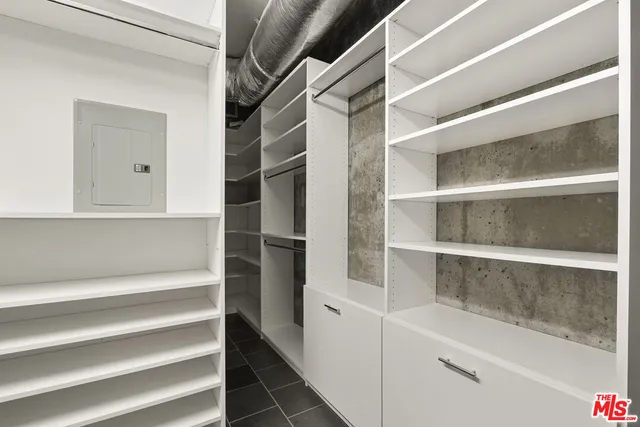 a view of a balcony with couches and potted plants