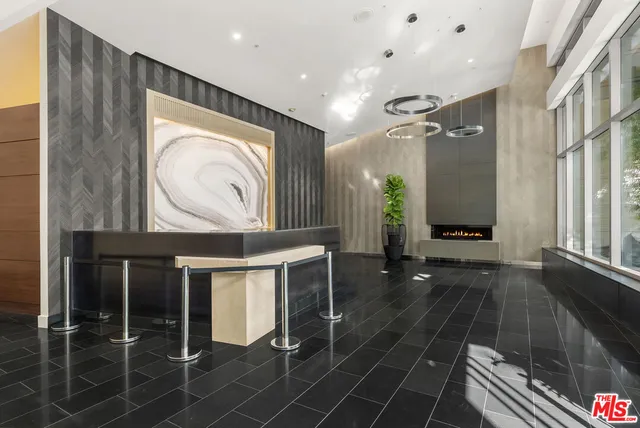 a balcony with couple of chairs and a table