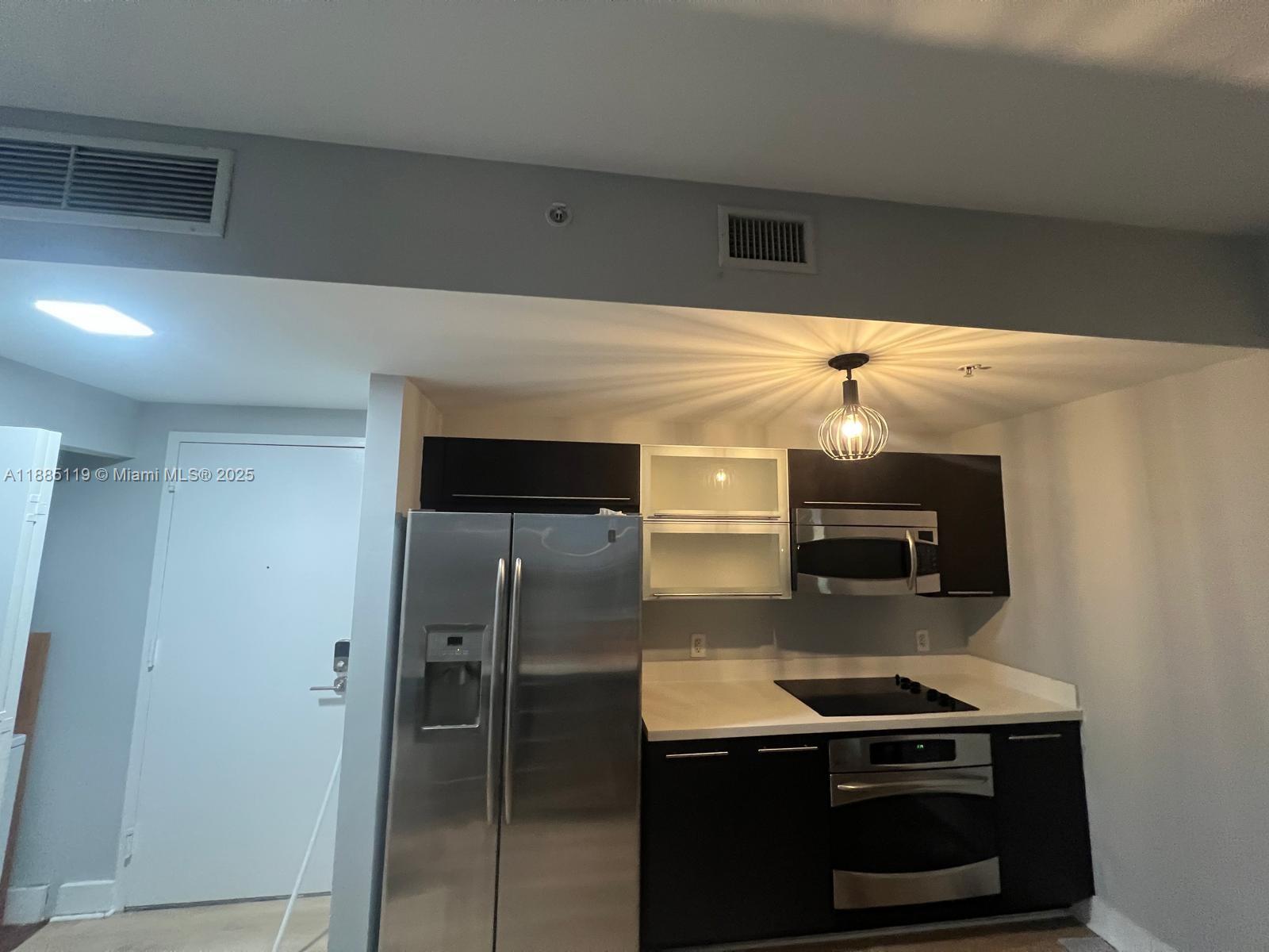 90 Southwest 3rd Street, Unit 4208 Miami, FL 33130 - Photo 11 of 17 a kitchen with stainless steel appliances a stove and a refrigerator