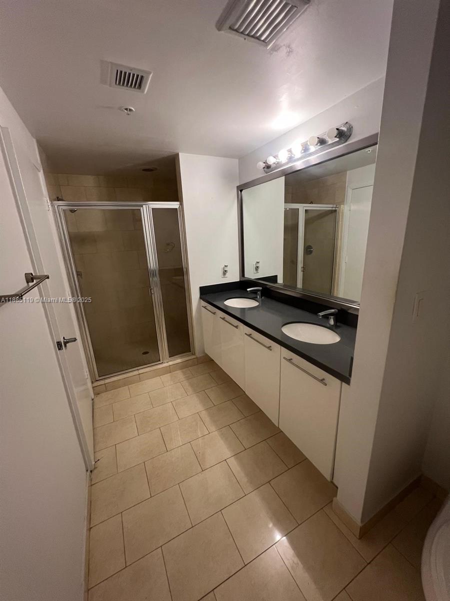 90 Southwest 3rd Street, Unit 4208 Miami, FL 33130 - Photo 15 of 17 a kitchen with granite countertop a sink and a stove top oven