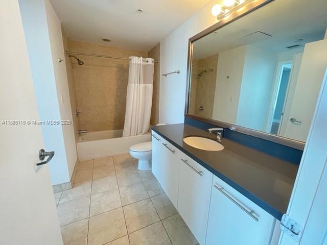 90 Southwest 3rd Street, Unit 4208 Miami, FL 33130 - Photo 8 of 17 a bathroom with a granite countertop sink a toilet and shower