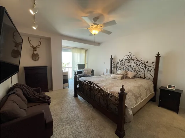 a bedroom with a bed couch and window