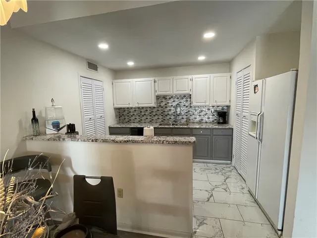 a kitchen with a sink appliances and cabinets