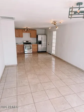 a view of a kitchen with furniture and an empty room