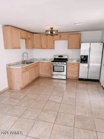 a large kitchen with granite countertop a stove a sink and a granite counter tops