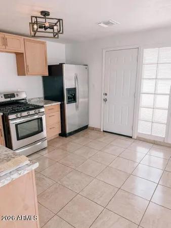 a kitchen with stainless steel appliances a sink a stove a microwave a counter top and cabinets