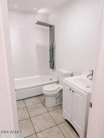 a bathroom with a toilet a sink and a mirror