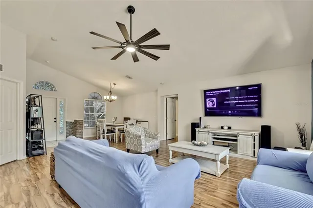 a kitchen with stainless steel appliances granite countertop a stove top oven a sink a dining table and chairs