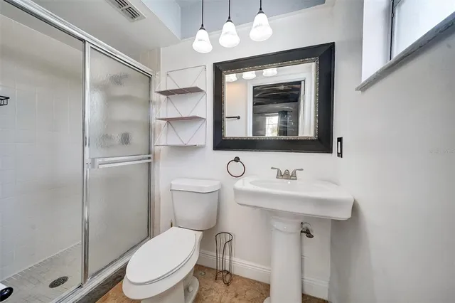 a view of a livingroom with a chandelier fan