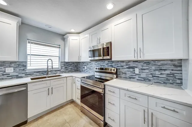 a large room with a large window and a fireplace