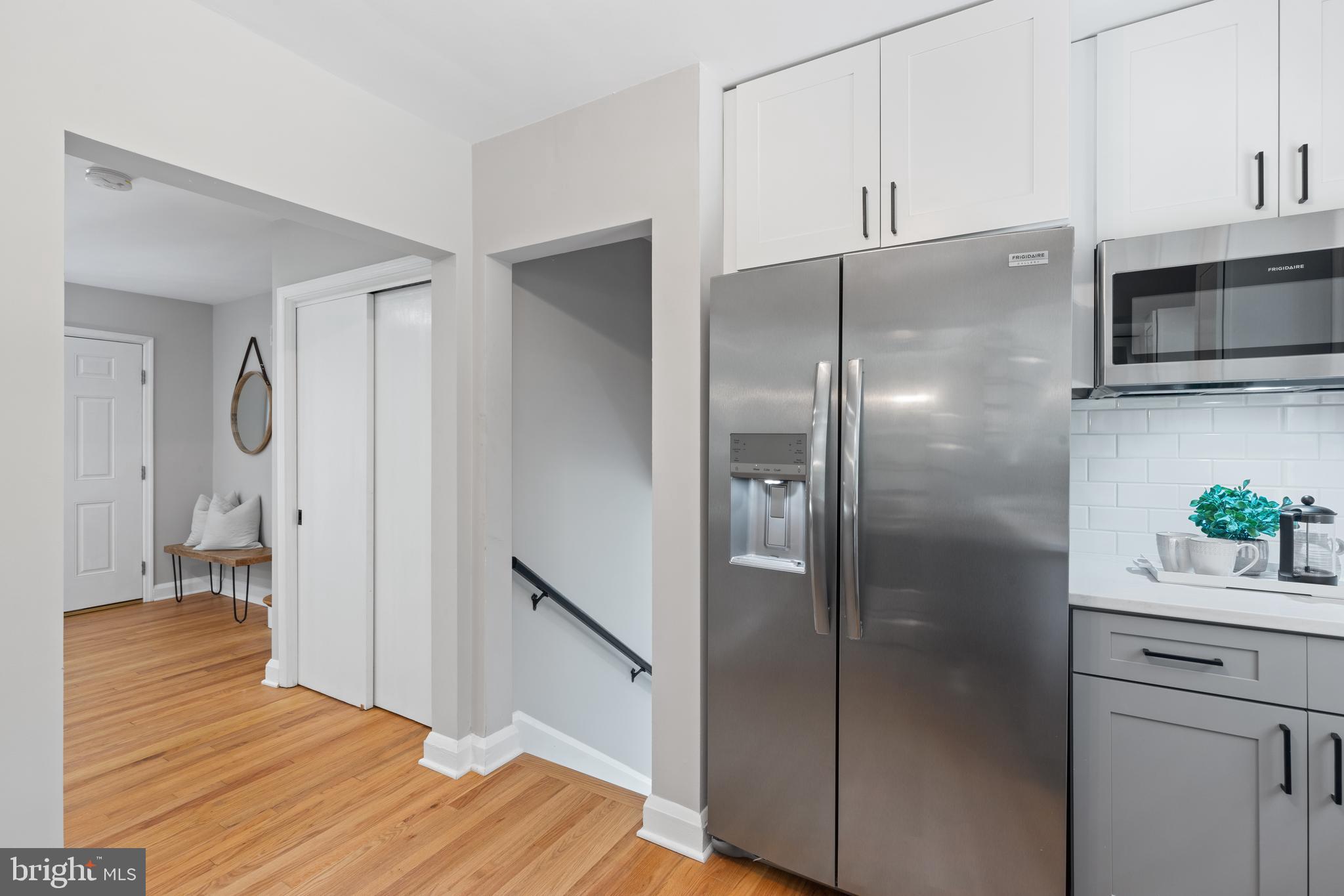 7003 Wardman Road Baltimore, MD 21212 - Photo 17 of 42 a kitchen with stainless steel appliances a refrigerator and a wooden floor
