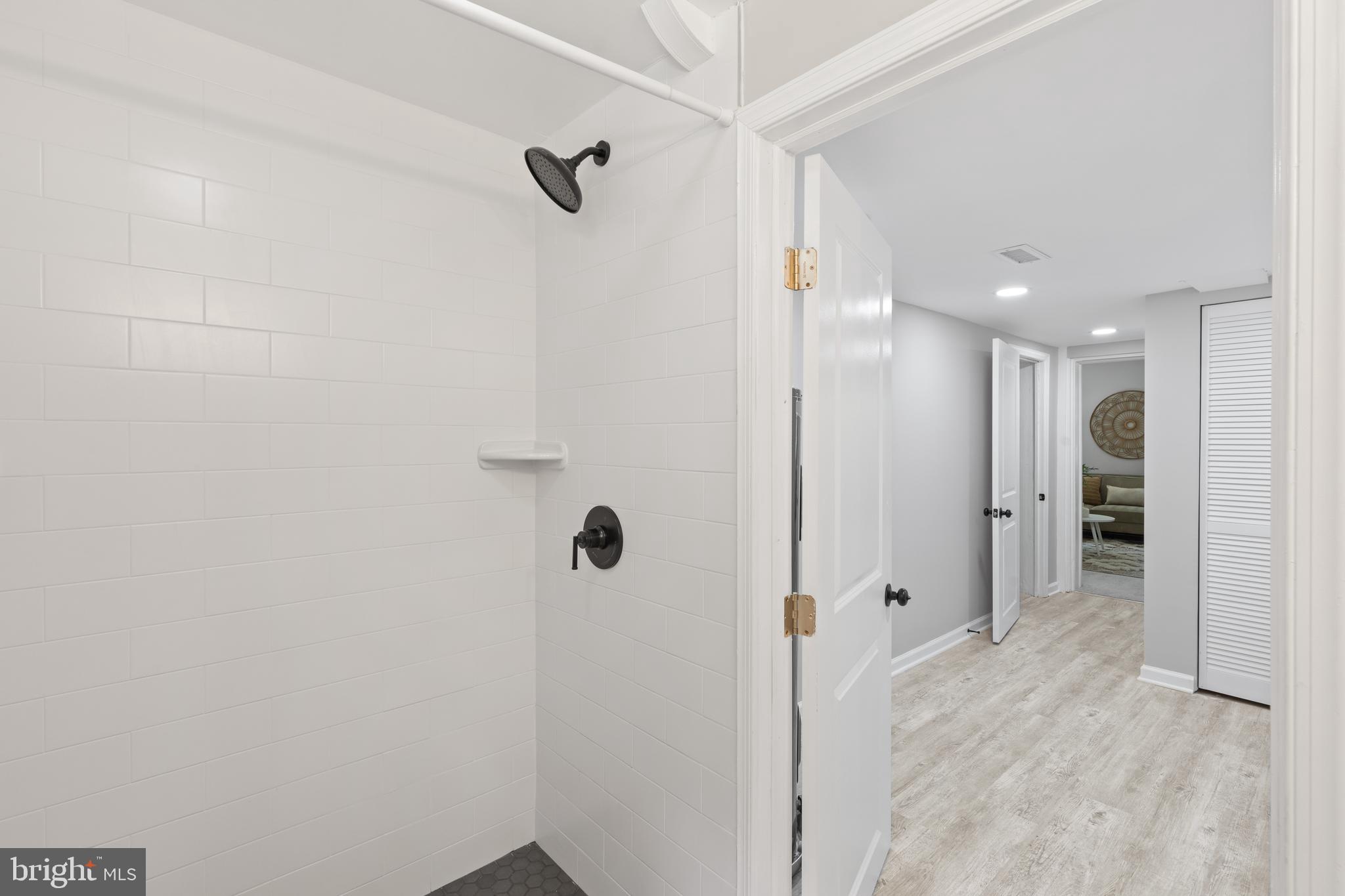 7003 Wardman Road Baltimore, MD 21212 - Photo 38 of 42 a bathroom with a shower and a glass door