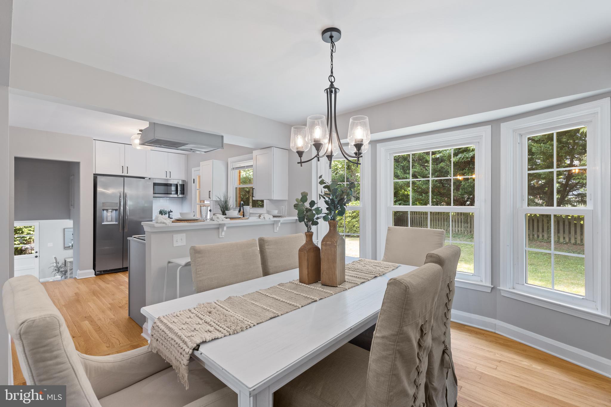 7003 Wardman Road Baltimore, MD 21212 - Photo 10 of 42 a dining room with furniture a chandelier and wooden floor