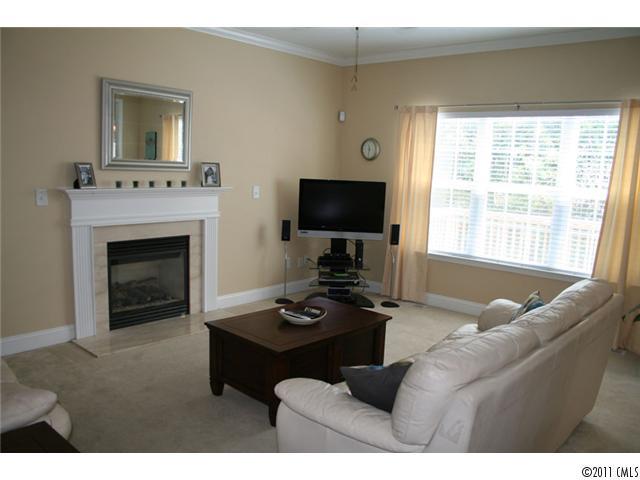 1826 Sam Smith Road, Unit 3 Fort Mill, SC 29708 - Photo 6 of 16 a living room with furniture a fireplace and a flat screen tv