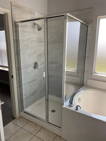 a bathroom with a bathtub and a shower