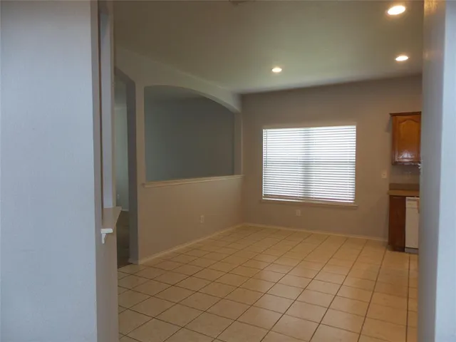 a view of an empty room and a window