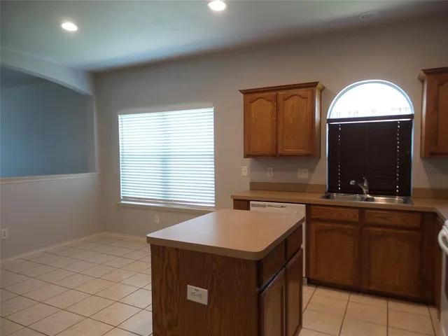 a kitchen with a sink cabinets and window