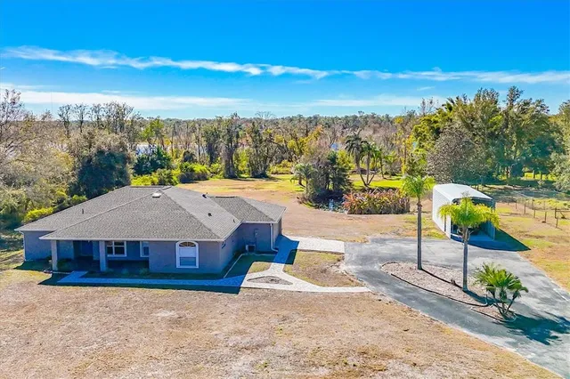 a view of a lake with couches in front of house