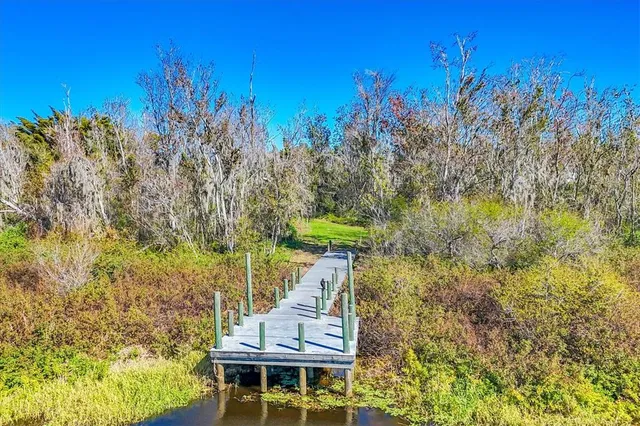 a view of a yard with wooden fence