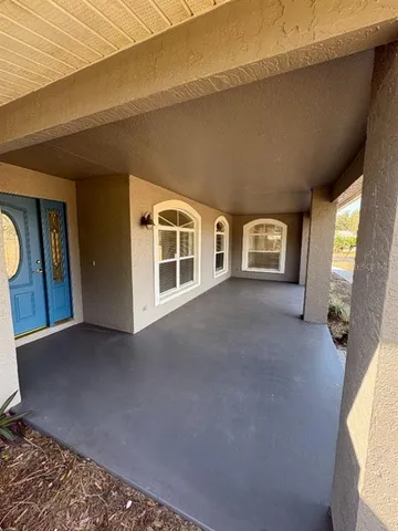 a view of empty room with wooden floor and window