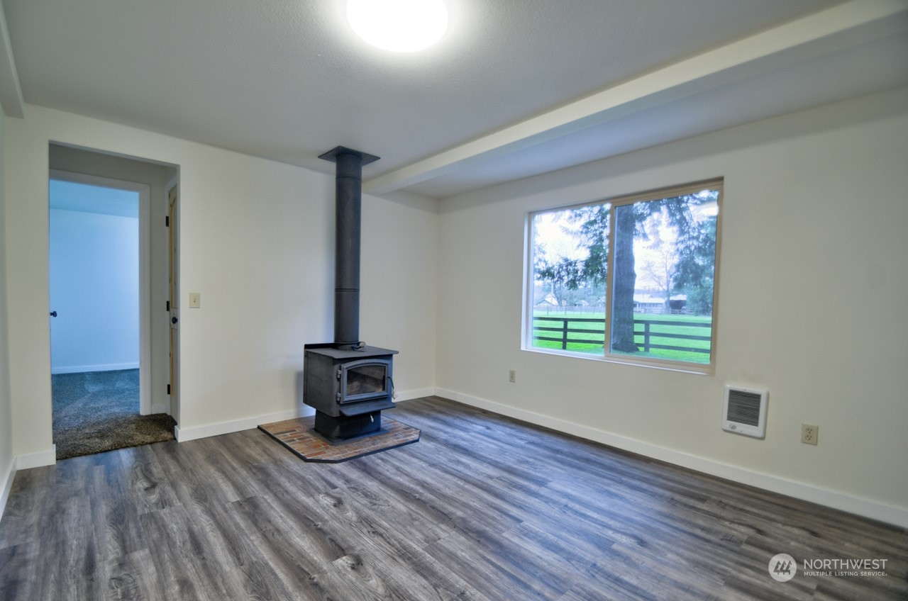 20020 Carper Road Southwest Rochester, WA 98579 - Photo 14 of 35 a view of an empty room with wooden floor and a window