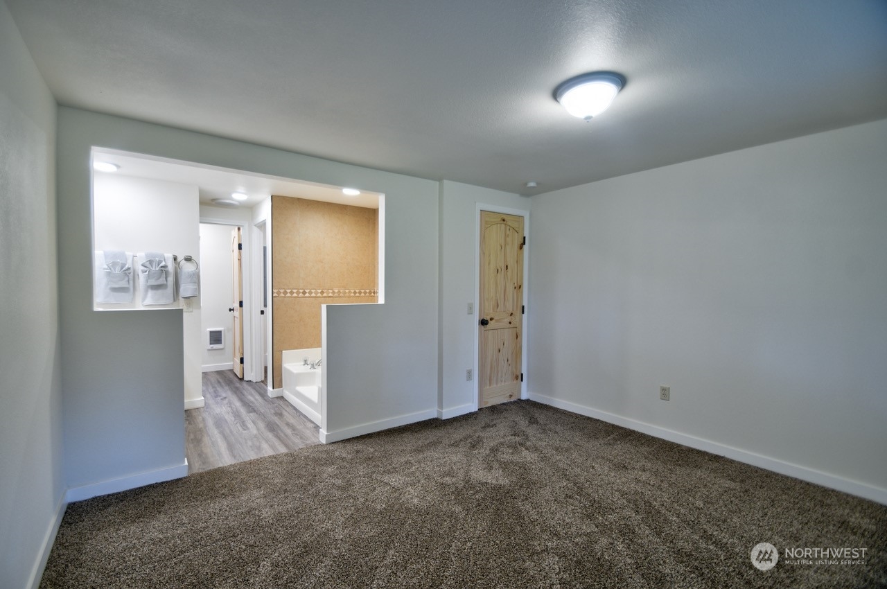 20020 Carper Road Southwest Rochester, WA 98579 - Photo 16 of 35 a view of a big room with closet and wooden floor