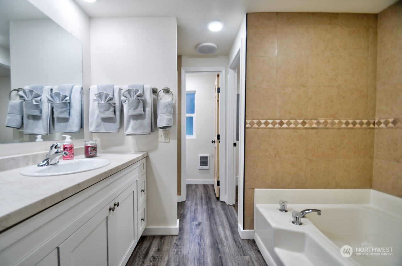 20020 Carper Road Southwest Rochester, WA 98579 - Photo 18 of 35 a bathroom with a bathtub sink and mirror
