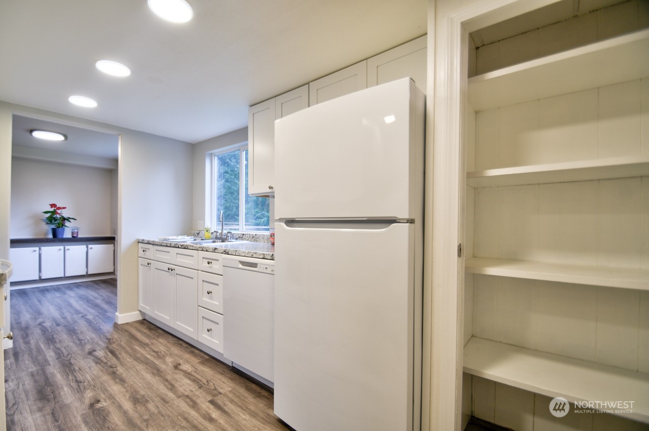 20020 Carper Road Southwest Rochester, WA 98579 - Photo 8 of 35 a kitchen with stainless steel appliances granite countertop a refrigerator and a stove top oven
