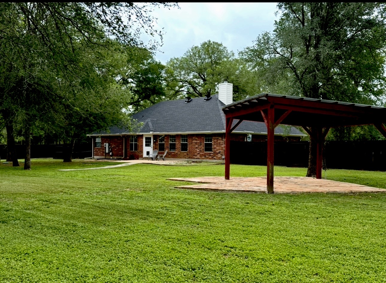 104 Spring Branch Bastrop, TX 78602 - Photo 6 of 32 Expansive green yard with mature trees