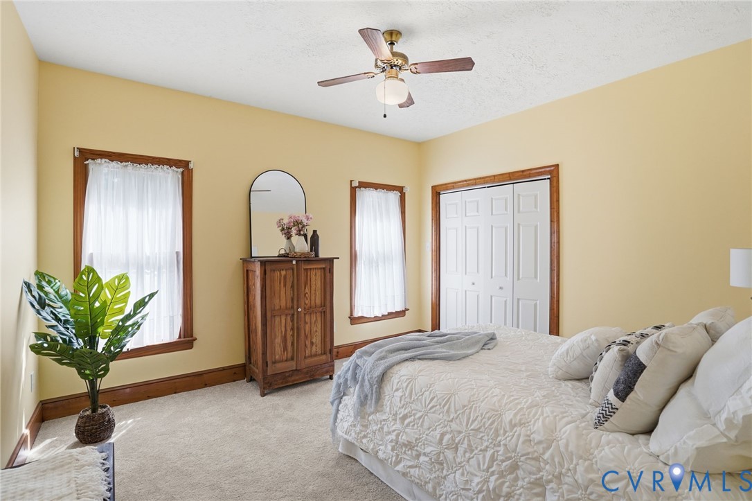12123 Deer Ridge Court Ashland, VA 23005 - Photo 25 of 63 a bedroom with a bed and a chandelier