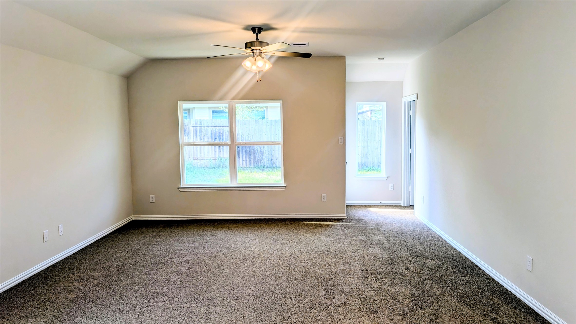 32314 Mimosa Ridge Lane Waller, TX 77484 - Photo 4 of 16 an empty room with windows and fan