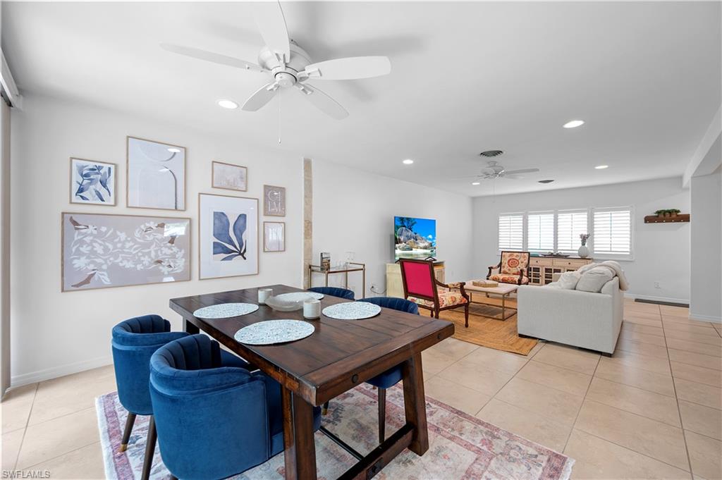 Dining area with ceiling fan, light tile patterned flooring, and recessed lighting