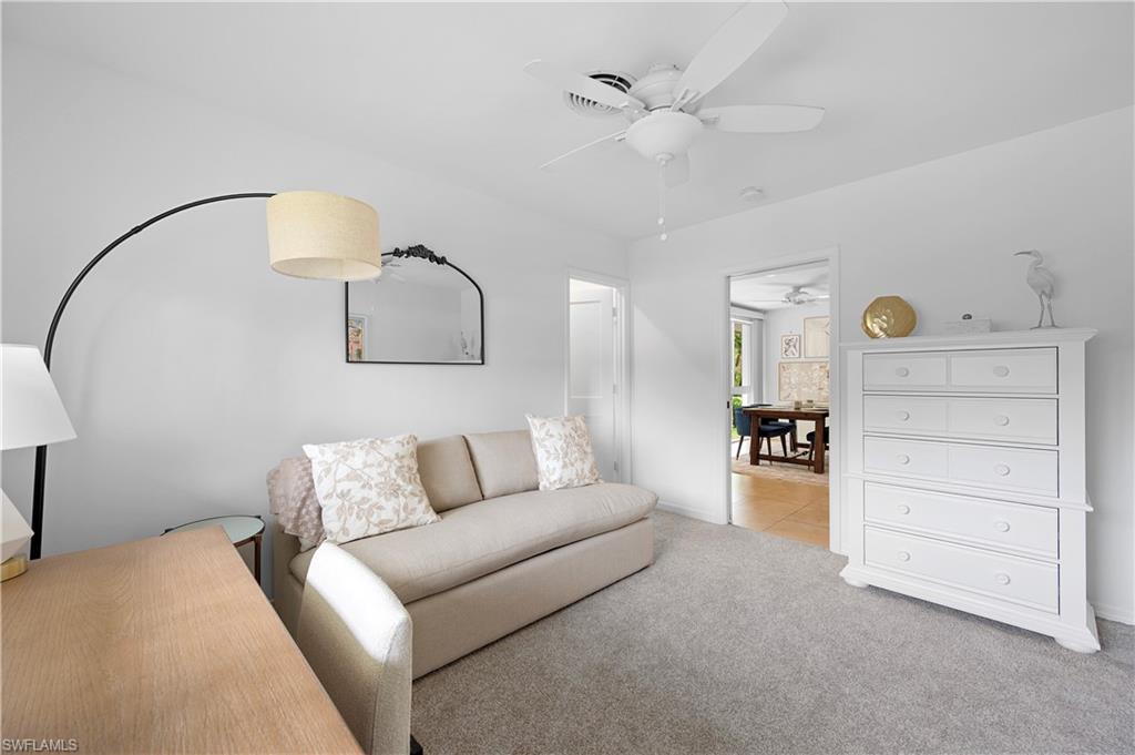 1340 Crayton Road, Unit 4 Naples, FL 34102 - Photo 11 of 22 Carpeted living room with ceiling fan