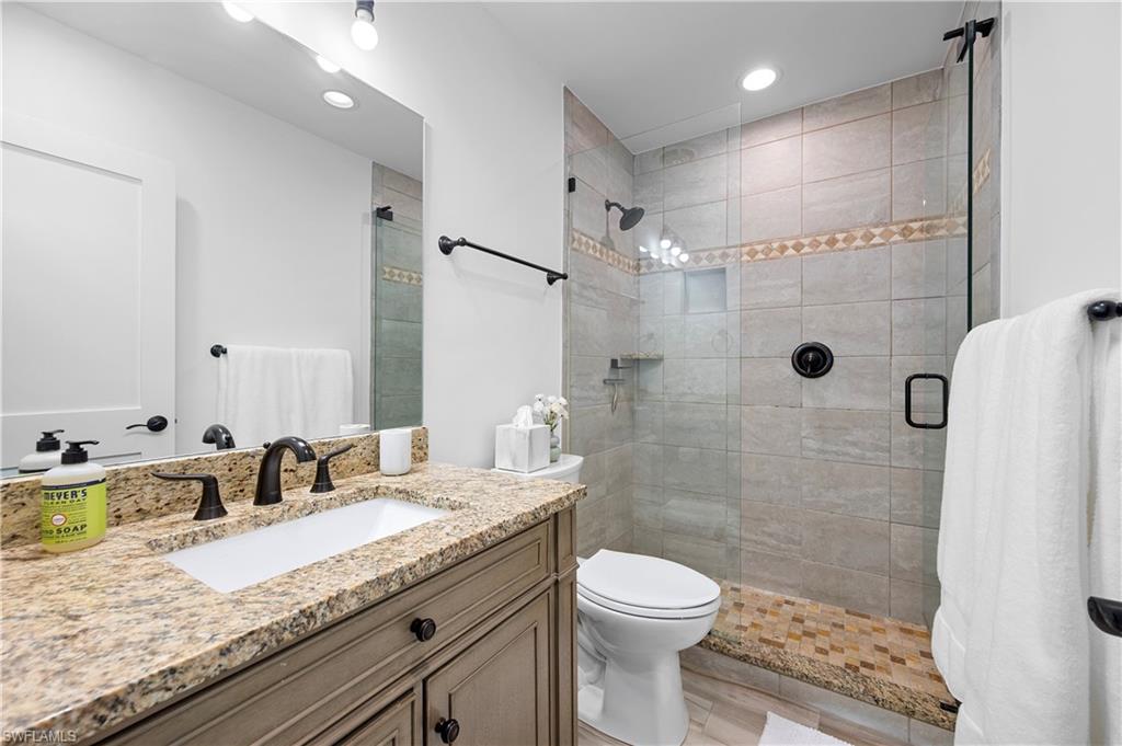 1340 Crayton Road, Unit 4 Naples, FL 34102 - Photo 21 of 22 Full bathroom with vanity, a shower stall, and recessed lighting