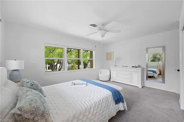a bedroom with a large bed and a window