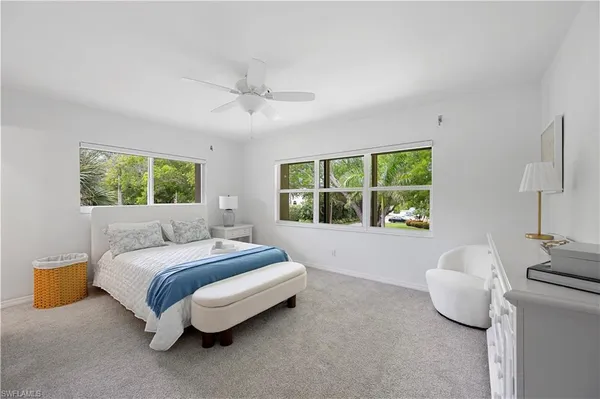 a spacious bedroom with a bed and window