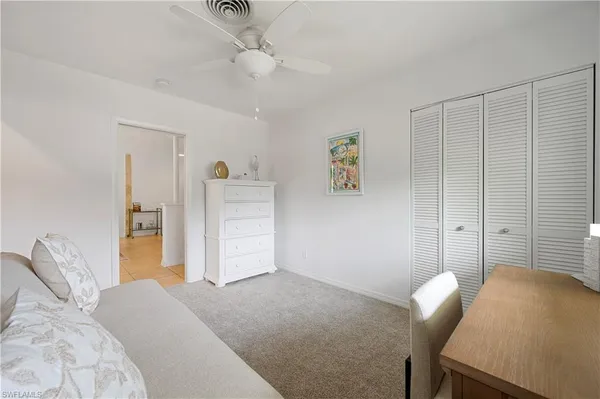 a bedroom with a bed and cabinets