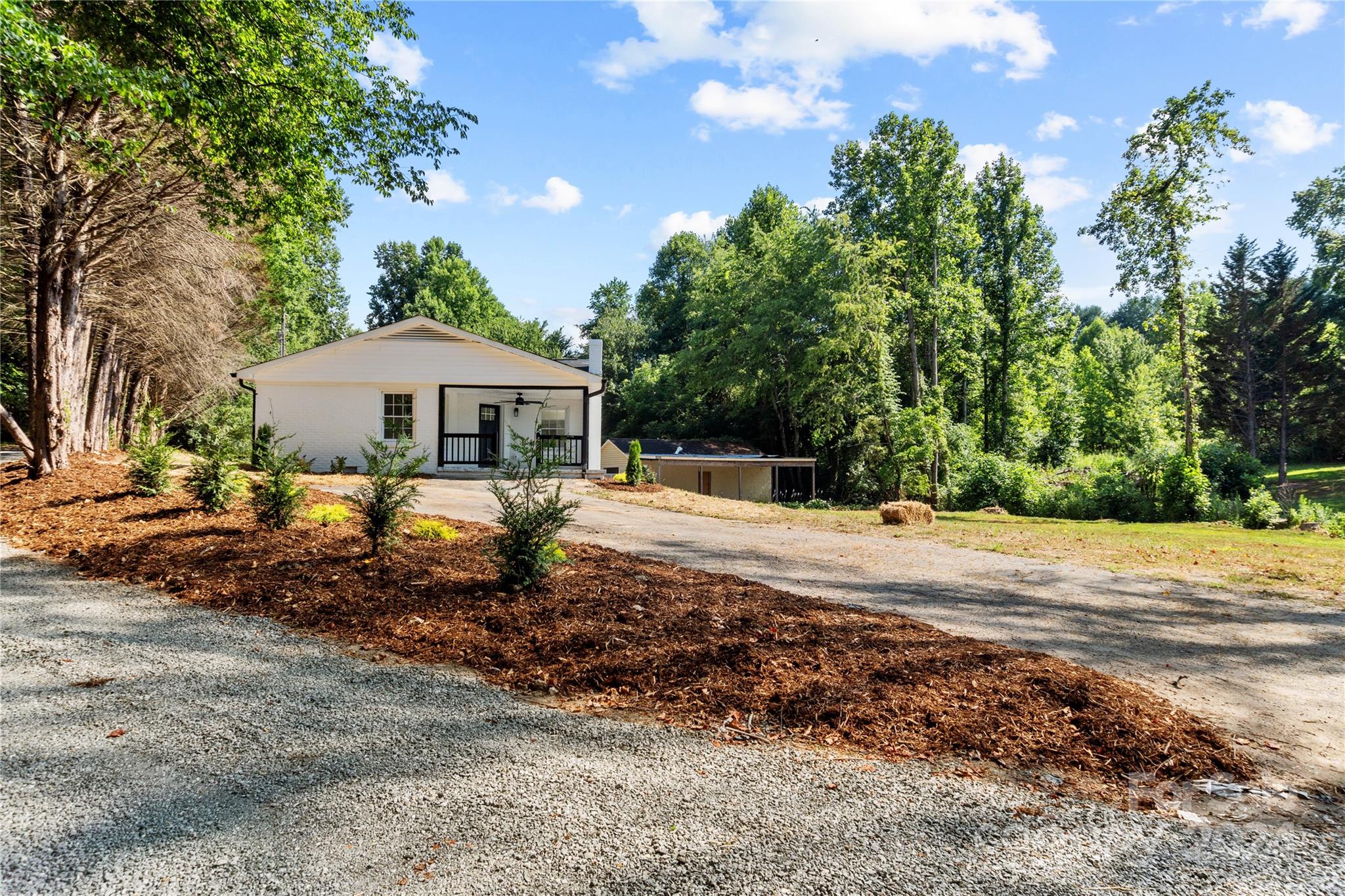 4879 Joe Powell Road Morganton, NC 28655 - Photo 1 of 35 a front view of a house with a yard and trees