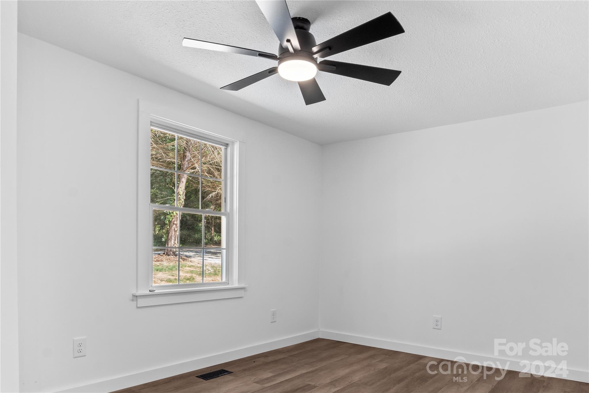 4879 Joe Powell Road Morganton, NC 28655 - Photo 20 of 35 an empty room with wooden floor and windows