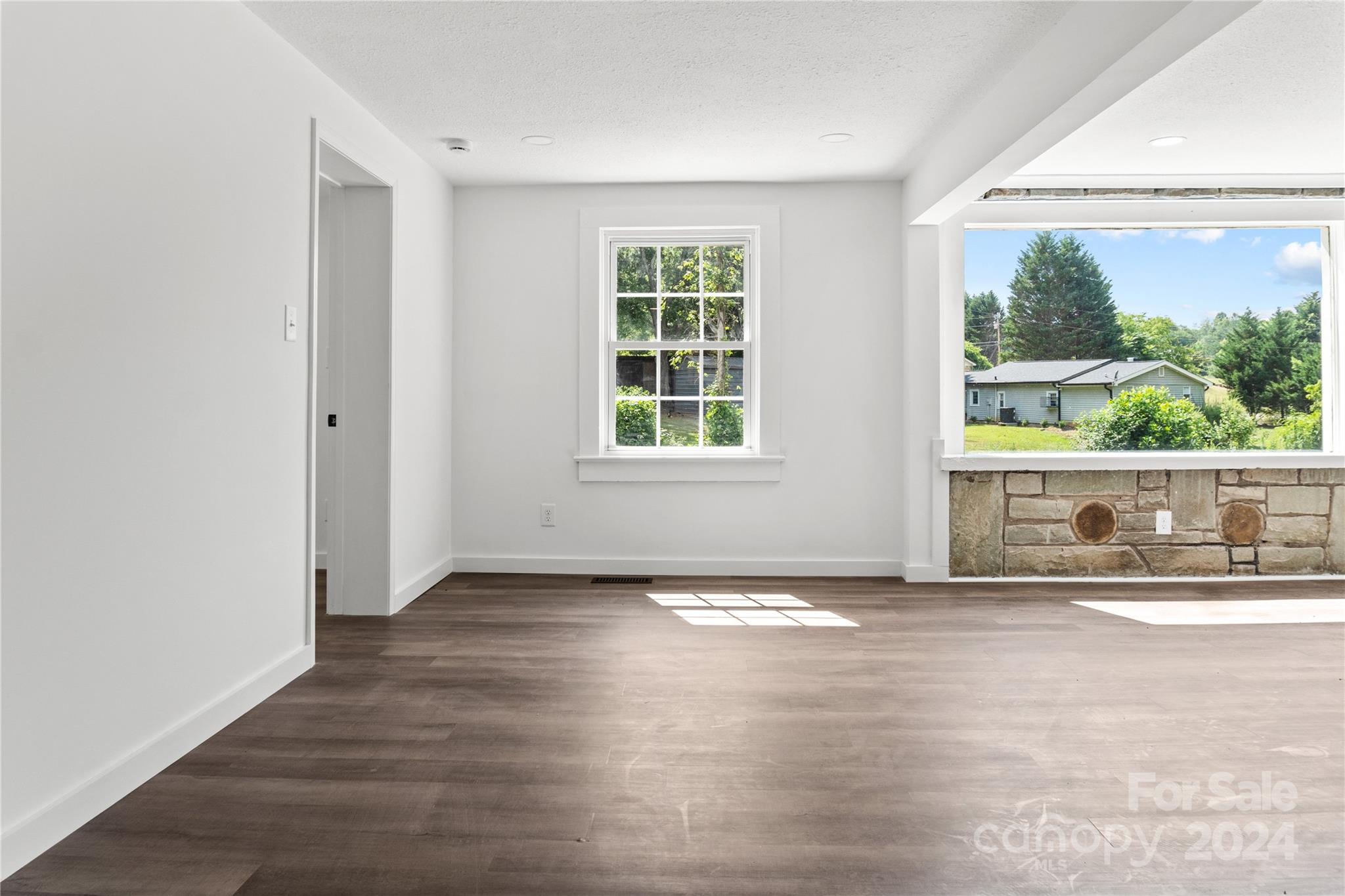 4879 Joe Powell Road Morganton, NC 28655 - Photo 21 of 35 an empty room with wooden floor and windows
