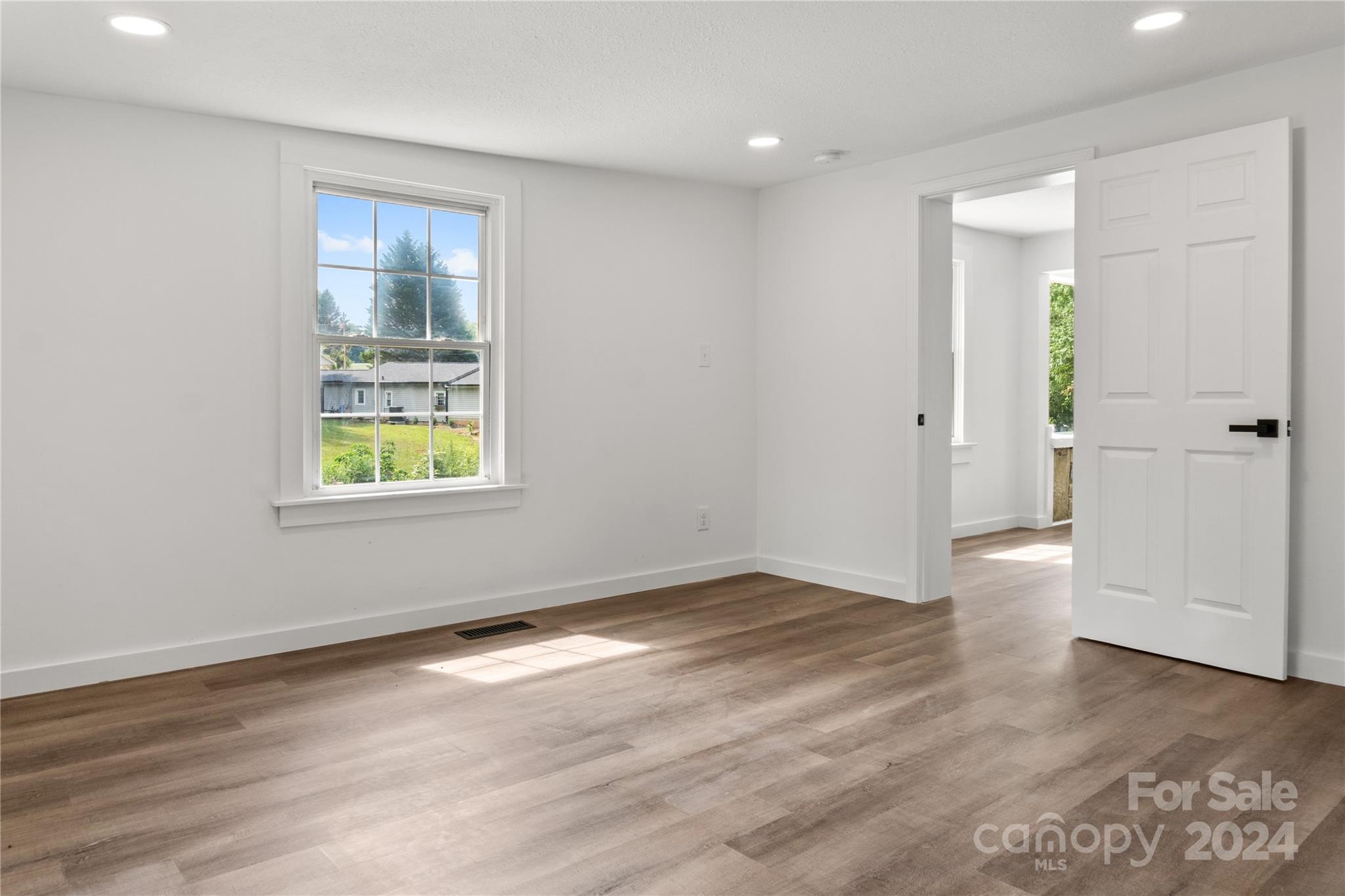 4879 Joe Powell Road Morganton, NC 28655 - Photo 29 of 35 an empty room with wooden floor and windows